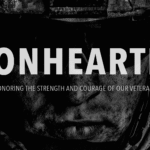 A combat veteran painting in a dimly lit studio, surrounded by canvases filled with raw, emotional brushstrokes.